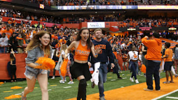 SYRACUSE, NY - OCTOBER 13: Syracuse Orange fans rush to mid-field of the Carrier Dome to celebrate the Orange's 27-24 victory over
