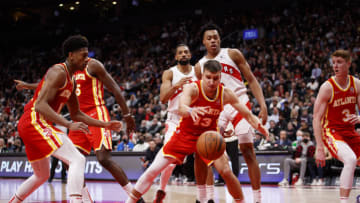TORONTO, ON - APRIL 05: Bogdan Bogdanovic #13 of the Atlanta Hawks tries to grab a loose ball in the key during the second half of their NBA game against the Toronto Raptors at Scotiabank Arena on April 5, 2022 in Toronto, Canada. NOTE TO USER: User expressly acknowledges and agrees that, by downloading and or using this Photograph, user is consenting to the terms and conditions of the Getty Images License Agreement. (Photo by Cole Burston/Getty Images)