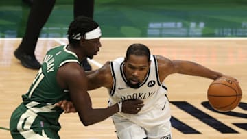 MILWAUKEE, WISCONSIN - MAY 02: Kevin Durant #7 of the Brooklyn Nets is defended by Jrue Holiday #21 of the Milwaukee Bucks during the first half of a game at Fiserv Forum on May 02, 2021 in Milwaukee, Wisconsin. NOTE TO USER: User expressly acknowledges and agrees that, by downloading and or using this photograph, User is consenting to the terms and conditions of the Getty Images License Agreement. (Photo by Stacy Revere/Getty Images)