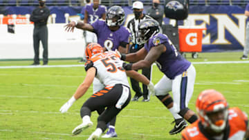 Oct 11, 2020; Baltimore, Maryland, USA; Baltimore Ravens quarterback Lamar Jackson (8) throws as Cincinnati Bengals linebacker Logan Wilson (55) applies pressure during the first quarter at M&T Bank Stadium. Mandatory Credit: Tommy Gilligan-USA TODAY Sports