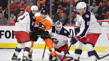Jan 20, 2022; Philadelphia, Pennsylvania, USA; Columbus Blue Jackets defenseman Zach Werenski (8) looks to clear the puck from Philadelphia Flyers left wing James van Riemsdyk (25) in front of goaltender Elvis Merzlikins (90) during the second period at Wells Fargo Center. Mandatory Credit: Eric Hartline-USA TODAY Sports