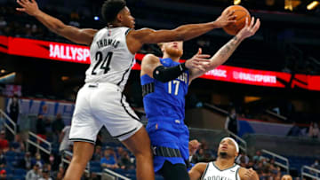 Nov 10, 2021; Orlando, Florida, USA; Brooklyn Nets guard Cam Thomas (24) blocks a shot by Orlando Magic forward Ignas Brazdeikis (17) during the second half at Amway Center. Mandatory Credit: Kim Klement-USA TODAY Sports