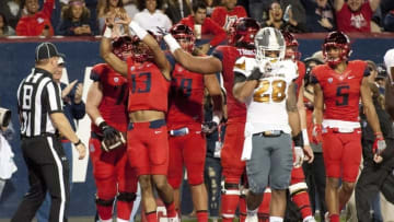 Nov 25, 2016; Tucson, AZ, USA; Arizona Wildcats quarterback Brandon Dawkins (13) celebrates after scoring a touchdown against the Arizona State Sun Devils during the second quarter of the Territorial Cup at Arizona Stadium. Mandatory Credit: Casey Sapio-USA TODAY Sports