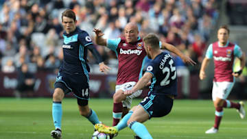 LONDON, ENGLAND - OCTOBER 01: West Ham United's Gokhan Tore is tackled by Middlesbrough's Calum Chambers during the Premier League match between West Ham United and Middlesbrough at Olympic Stadium on October 1, 2016 in London, England. (Photo by Rob Newell - CameraSport/CameraSport via Getty Images)