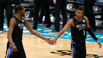 CHARLOTTE, NORTH CAROLINA - DECEMBER 27: Kevin Durant #7 and Timothe Luwawu-Cabarrot #9 of the Brooklyn Nets slap hands following a play during the fourth quarter of their game against the Charlotte Hornets at Spectrum Center on December 27, 2020 in Charlotte, North Carolina. NOTE TO USER: User expressly acknowledges and agrees that, by downloading and or using this photograph, User is consenting to the terms and conditions of the Getty Images License Agreement. (Photo by Jared C. Tilton/Getty Images)