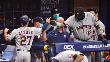 ST PETERSBURG, FLORIDA - MAY 01: Jose Altuve #27 celebrates with manager Dusty Baker Jr. #12 of the Houston Astros after scoring in the first inning against the Tampa Bay Rays at Tropicana Field on May 01, 2021 in St Petersburg, Florida. (Photo by Julio Aguilar/Getty Images)