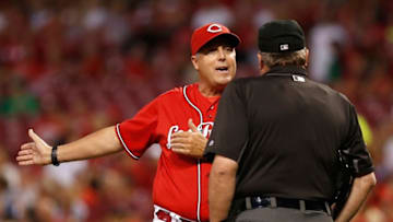 Sep 16, 2016; Cincinnati, OH, USA; Cincinnati Reds manager Bryan Price (left) questions a call with home plate umpire Gerry Davis (right) during the first inning against the Pittsburgh Pirates at Great American Ball Park. Mandatory Credit: David Kohl-USA TODAY Sports