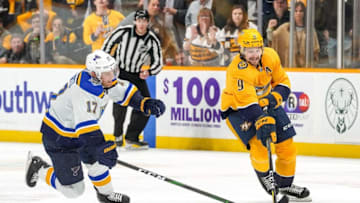NASHVILLE, TN - NOVEMBER 25: Filip Forsberg #9 of the Nashville Predators battles for the puck against Jaden Schwartz #17 of the St. Louis Blues at Bridgestone Arena on November 25, 2019 in Nashville, Tennessee. (Photo by John Russell/NHLI via Getty Images)