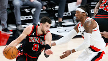 PORTLAND, OREGON - JANUARY 05: Zach LaVine #8 of the Chicago Bulls dribbles around Robert Covington #23 of the Portland Trail Blazers in the fourth quarter at Moda Center on January 05, 2021 in Portland, Oregon. NOTE TO USER: User expressly acknowledges and agrees that, by downloading and or using this photograph, User is consenting to the terms and conditions of the Getty Images License Agreement. (Photo by Steph Chambers/Getty Images)