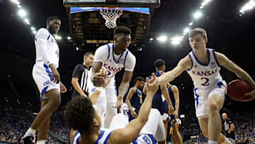 LAWRENCE, KANSAS - DECEMBER 14: Devon Dotson #1 of the Kansas Jayhawks is helped up by Silvio De Sousa #22 and Christian Braun #2 after being fouled during the game against the UMKC Kangaroos at Allen Fieldhouse on December 14, 2019 in Lawrence, Kansas. (Photo by Jamie Squire/Getty Images)