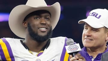 Dec 29, 2015; Houston, TX, USA; MVP LSU Tigers running back Leonard Fournette (7) and head coach Les Miles talks to a reporter after defeating the Texas Tech Red Raiders at NRG Stadium. LSU won 56 to 27. Mandatory Credit: Thomas B. Shea-USA TODAY Sports