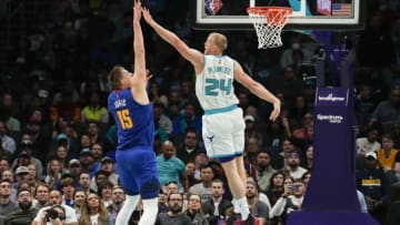 Mar 28, 2022; Charlotte, North Carolina, USA; Charlotte Hornets center Mason Plumlee (24) tries to block Denver Nuggets center Nikola Jokic (15) during the second half at Spectrum Center. Mandatory Credit: Jim Dedmon-USA TODAY Sports