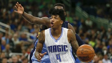 Dec 26, 2016; Orlando, FL, USA; Orlando Magic guard Elfrid Payton (4) drives around Memphis Grizzlies forward James Ennis (8) during the second half of an NBA basketball game at Amway Center. The Magic won 112-202. Mandatory Credit: Reinhold Matay-USA TODAY Sports