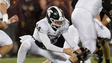 MINNEAPOLIS, MN - OCTOBER 14: Brian Lewerke #14 of the Michigan State Spartans fumbles the ball during the first quarter of the game against the Minnesota Golden Gophers on October 14, 2017 at TCF Bank Stadium in Minneapolis, Minnesota. (Photo by Hannah Foslien/Getty Images)