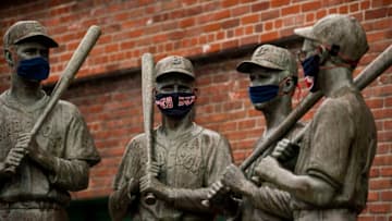 BOSTON, MA - APRIL 9: The "Teammates" statues of former Boston Red Sox players Ted Williams, Bobby Doerr, Johnny Pesky and Dom DiMaggio wear makeshift masks made of Red Sox merchandise as the Major League Baseball season is postponed due the coronavirus pandemic on April 9, 2020 at Fenway Park in Boston, Massachusetts. (Photo by Billie Weiss/Boston Red Sox/Getty Images)