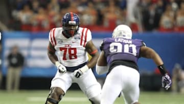 Dec 31, 2014; Atlanta , GA, USA; Mississippi Rebels offensive lineman Laremy Tunsil (78) prepares to block TCU Horned Frogs defensive tackle Terrell Lathan (90) during the first quarter in the 2014 Peach Bowl at the Georgia Dome. Mandatory Credit: Brett Davis-USA TODAY Sports