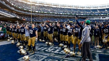 NEW YORK, NY - DECEMBER 28: The Notre Dame Fighting Irish salute fans after winning against the Rutgers Scarlet Knights in the New Era Pinstripe Bowl at Yankee Stadium on December 28, 2013 in the Bronx borough of New York City. (Photo by Jeff Zelevansky/Getty Images)