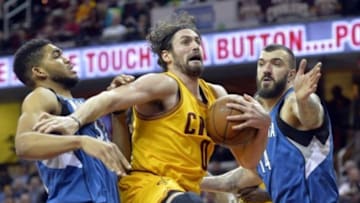 Jan 25, 2016; Cleveland, OH, USA; Cleveland Cavaliers forward Kevin Love (0) rebounds between Minnesota Timberwolves center Karl-Anthony Towns (32) and center Nikola Pekovic (14) in the third quarter at Quicken Loans Arena. Mandatory Credit: David Richard-USA TODAY Sports