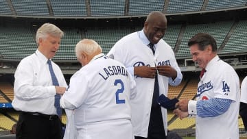 May 2, 2012; Los Angeles, CA, USA; Tommy Lasorda presents a jersey to Mark Walter as Steve Garvey gives a jersey to Magic Johnson at a press conference to announce their sale of the Los Angeles Dodgers to the Guggenheim baseball management team at Dodger Stadium. Mandatory Credit: Kirby Lee/Image of Sport-USA TODAY Sports
