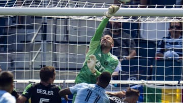 Austin FC goalkeeper Brad Stuver punches the ball against Sporting Kansas City. Mandatory Credit: Jay Biggerstaff-USA TODAY Sports