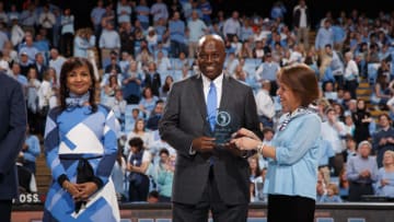 CHAPEL HILL, NC - FEBRUARY 20: North Carolina Tar Heel Phil Ford (center) awarded the Trailblazers Award by chancellor Carol Folt (R) during a game against the Miami Hurricanes on February 20, 2016 at the Dean E. Smith Center in Chapel Hill, North Carolina. North Carolina won 96-71. (Photo by Peyton Williams/UNC/Getty Images)