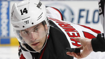 SUNRISE, FL - MARCH 30: Adam Henrique #14 of the New Jersey Devils waits for linesman Darren Gibbs #66 to drop the puck during a face-off against the Florida Panthers at the BB&T Center on March 30, 2013 in Sunrise, Florida. The Panthers defeated the Devils 3-2 in overtime. (Photo by Joel Auerbach/Getty Images)