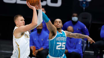 CHARLOTTE, NORTH CAROLINA - JANUARY 13: Kristaps Porzingis #6 of the Dallas Mavericks attempts a shot against P.J. Washington #25 of the Charlotte Hornets during the fourth quarter of their game at Spectrum Center on January 13, 2021 in Charlotte, North Carolina. NOTE TO USER: User expressly acknowledges and agrees that, by downloading and or using this photograph, User is consenting to the terms and conditions of the Getty Images License Agreement. (Photo by Jared C. Tilton/Getty Images)