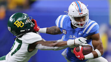 NEW ORLEANS, LOUISIANA - JANUARY 01: Jerrion Ealy #9 of the Mississippi Rebels stiff arms Tevin Williams III #27 of the Baylor Bears during the fourth quarter in the Allstate Sugar Bowl at Caesars Superdome on January 01, 2022 in New Orleans, Louisiana. (Photo by Jonathan Bachman/Getty Images)