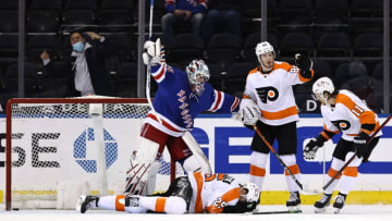 Apr 22, 2021; New York, New York, USA; Igor Shesterkin #31 of the New York Rangers signals for help after James van Riemsdyk #25 of the Philadelphia Flyers falls to the ice as teammates Joel Farabee #86 and Travis Konecny #11 of the Philadelphia Flyers stand by in the second period at Madison Square Garden. Riemsdyk was credited with the goal after it went into the net off of his face, Mandatory Credit: Elsa/POOL PHOTOS-USA TODAY Sports