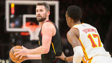 Mar 31, 2022; Atlanta, Georgia, USA; Cleveland Cavaliers forward Kevin Love (0) is defended by Atlanta Hawks forward Onyeka Okongwu (17) in the second quarter at State Farm Arena. Mandatory Credit: Brett Davis-USA TODAY Sports