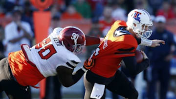 Jan 30, 2016; Mobile, AL, USA; South squad defensive end Jarran Reed of Alabama (90) tackles North squad quarterback Jeff Driskel of Louisiana Tech (16) for a loss during second half of the Senior Bowl at Ladd-Peebles Stadium. Mandatory Credit: Butch Dill-USA TODAY Sports