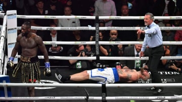 US boxer Deontay Wilder (L) knocks out Swedish-Finnish boxer Robert Helenius in the 1st round of their 12-round WBC World Heavyweight Title Eliminator fight at Barclays Center in Brooklyn, New York, on October 15, 2022. (Photo by ANGELA WEISS / AFP) (Photo by ANGELA WEISS/AFP via Getty Images)
