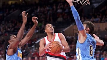 Nov 13, 2016; Portland, OR, USA; Portland Trail Blazers guard C.J. McCollum (3) shoots over Denver Nuggets forward Kenneth Faried (35) and forward Danilo Gallinari (8) during the fourth quarter at the Moda Center. Mandatory Credit: Craig Mitchelldyer-USA TODAY Sports