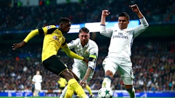 MADRID, SPAIN - DECEMBER 07: Ousmane Dembele of Borussia Dortmund is tackled by Sergio Ramos of Real Madrid and Casemiro of Real Madrid during the UEFA Champions League Group F match between Real Madrid CF and Borussia Dortmund at the Bernabeu on December 7, 2016 in Madrid, Spain. (Photo by Gonzalo Arroyo Moreno/Getty Images)