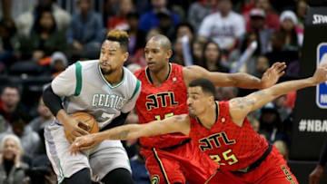 Nov 24, 2015; Atlanta, GA, USA; Boston Celtics center Jared Sullinger (7) drives against the defense of Atlanta Hawks center Al Horford (15) and guard Thabo Sefolosha (25) in the first quarter of their game at Philips Arena. Mandatory Credit: Jason Getz-USA TODAY Sports