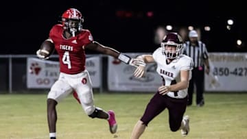 Tiger Jordan Pride looks for running room on a kickoff return. Blountstown hosted Baker under the lights for Friday night football October 22, 2021.018 102221 Blountstown Vs Baker Fb