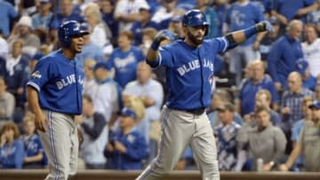 Oct 23, 2015; Kansas City, MO, USA; Toronto Blue Jays right fielder Jose Bautista (right) celebrates after hitting a two-run home run against the Kansas City Royals in the 8th inning in game six of the ALCS at Kauffman Stadium. Mandatory Credit: Denny Medley-USA TODAY Sports
