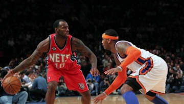 Dec 21, 2011; New York, NY, USA; New Jersey Nets small forward Damion James (10) looks to pass as New York Knicks small forward Carmelo Anthony (7) defends during the first quarter at Madison Square Garden. Mandatory Credit: Anthony Gruppuso-USA TODAY Sports