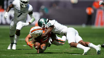 Sep 18, 2021; Miami Gardens, Florida, USA; Miami Hurricanes wide receiver Xavier Restrepo (7) and Michigan State Spartans safety Angelo Grose (15) attempt to recover the fumble of quarterback D'Eriq King (not pictured) during the first half at Hard Rock Stadium. Mandatory Credit: Jasen Vinlove-USA TODAY Sports