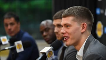EL SEGUNDO, CA - JUNE 26: Sviatoslav Mykhailiuk #15 answers questions from the media as general manager Rob Pelinka, president of basketball operations Magic Johnson, and Moritz Wagner #9 of the Los Angeles Lakers listen during a press conference to introduce the 2018 draft picks, at the UCLA Health Training Center on June 26, 2018 in El Segundo, California. Wagner was chosen with the 25th overall pick and Mykhailiuk with the 47th pick. TO USER: User expressly acknowledges and agrees that, by downloading and/or using this Photograph, User is consenting to the terms and conditions of the Getty Images License Agreement. (Photo by Jayne Kamin-Oncea/Getty Images)