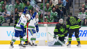 Mar 26, 2022; Dallas, Texas, USA; Vancouver Canucks center Bo Horvat (53) and right wing Brock Boeser (6) celebrates a goal scored by center Elias Pettersson (not pictured) against Dallas Stars goaltender Jake Oettinger (29) during the second period at the American Airlines Center. Mandatory Credit: Jerome Miron-USA TODAY Sports