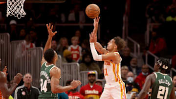 Nov 14, 2021; Atlanta, Georgia, USA; Atlanta Hawks guard Trae Young (11) attempts a shot against Milwaukee Bucks forward Giannis Antetokounmpo (34) during the second half at State Farm Arena. Mandatory Credit: Jason Getz-USA TODAY Sports