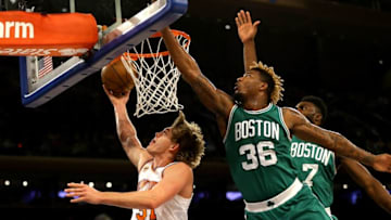 Oct 15, 2016; New York, NY, USA; New York Knicks forward Mindaugas Kuzminskas (91) goes up for a shot against Boston Celtics guard Marcus Smart (36) during the first half at Madison Square Garden. The Celtics won 119-107. Mandatory Credit: Andy Marlin-USA TODAY Sports