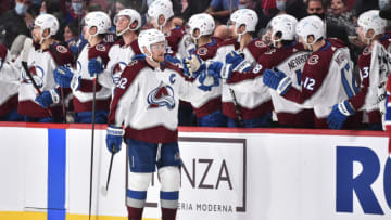 MONTREAL, QC - DECEMBER 02: Gabriel Landeskog #92 of the Colorado Avalanche celebrates with teammates on the bench during the second period against the Montreal Canadiens at Centre Bell on December 2, 2021 in Montreal, Canada. The Colorado Avalanche defeated the Montreal Canadiens 4-1. (Photo by Minas Panagiotakis/Getty Images)