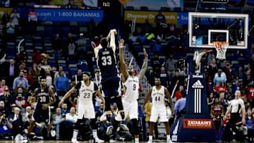 Dec 5, 2016; New Orleans, LA, USA; Memphis Grizzlies center Marc Gasol (33) shoots a three pointer over New Orleans Pelicans forward Terrence Jones (9) in the final seconds of the fourth quarter of a game at the Smoothie King Center. The Grizzlies defeated the Pelicans 110-108 in double overtime. Mandatory Credit: Derick E. Hingle-USA TODAY Sports
