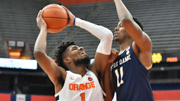 Feb 20, 2021; Syracuse, New York, USA; Syracuse Orange forward Quincy Guerrier (1) is pressured by Notre Dame Fighting Irish forward Juwan Durham (11) in the first half at the Carrier Dome. Mandatory Credit: Mark Konezny-USA TODAY Sports
