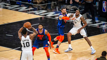 OKC Thunder Forward Paul George defends Spurs Guard DeMar DeRozan (Photos by Zach Beeker/NBAE via Getty Images)