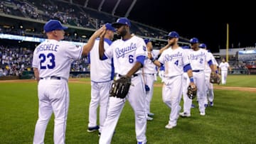KANSAS CITY, MO - AUGUST 22: Lorenzo Cain #6, Alex Gordon #4, and Alcides Escobar #2 of the Kansas City Royals high-five teammates after the Royals defeated the Colorado Rockies 3-2 to win the game at Kauffman Stadium on August 22, 2017 in Kansas City, Missouri. (Photo by Jamie Squire/Getty Images)