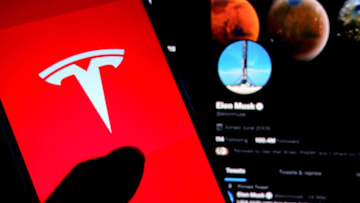 INDIA - 2022/07/07: In this photo illustration, a Tesla logo is displayed on a smartphone screen with Elon Musk Twitter page in the background. (Photo Illustration by Avishek Das/SOPA Images/LightRocket via Getty Images)