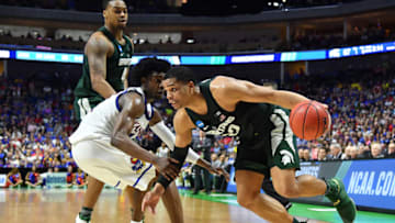 TULSA, OK - MARCH 19: Miles Bridges #22 of the Michigan State Spartans drives to the basket defended by Josh Jackson #11 of the Kansas Jayhawks during the second round of the 2017 NCAA Men's Basketball Tournament at BOK Center on March 19, 2017 in Tulsa, Oklahoma. (Photo by J Pat Carter/Getty Images)